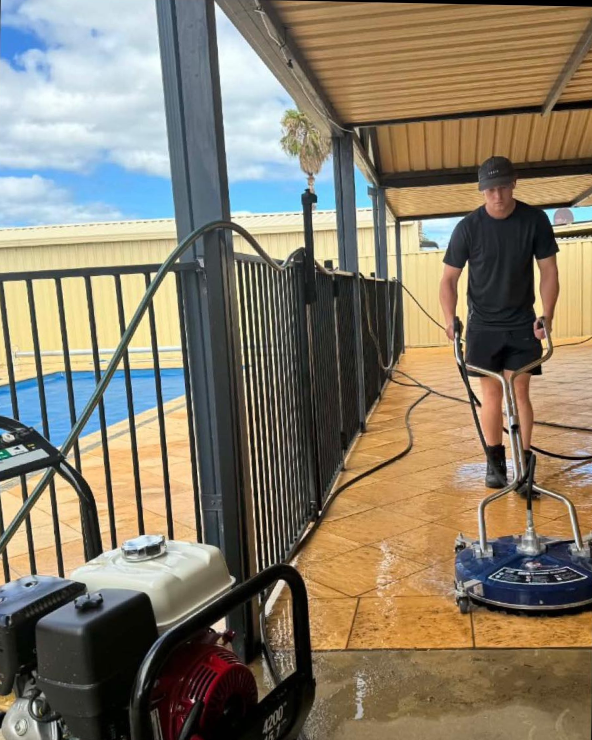 Coastal Power Clean operator pressure washing a patio in Mandurah